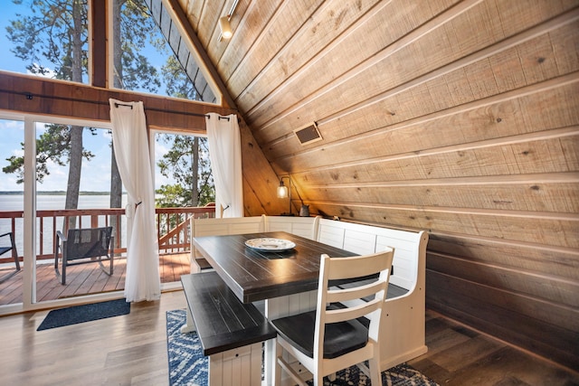 169 N County Road 4945, Etoile, TX 75944 - dining area featuring wooden walls, lofted ceiling, wood finished floors, wooden ceiling, and a water view