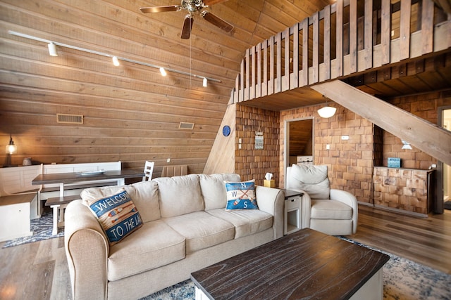 169 N County Road 4945, Etoile, TX 75944 - living area with wood walls, a ceiling fan, wood finished floors, wood ceiling, and track lighting