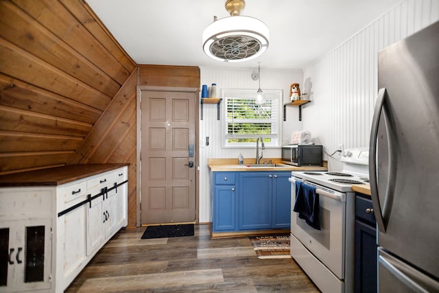 169 N County Road 4945, Etoile, TX 75944 - kitchen with freestanding refrigerator, white electric stove, blue cabinets, wooden counters, and open shelves