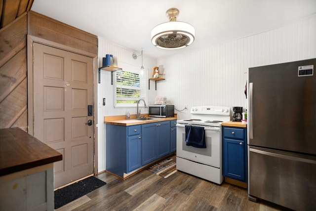 169 N County Road 4945, Etoile, TX 75944 - kitchen with appliances with stainless steel finishes, blue cabinetry, butcher block counters, dark wood-style floors, and open shelves