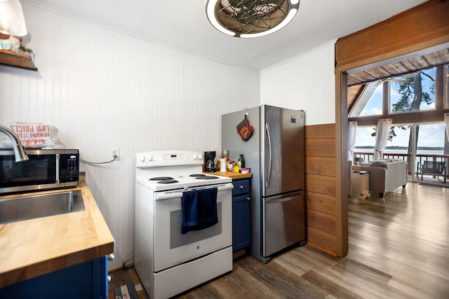 169 N County Road 4945, Etoile, TX 75944 - kitchen featuring appliances with stainless steel finishes, blue cabinets, butcher block countertops, dark wood finished floors, and ornamental molding