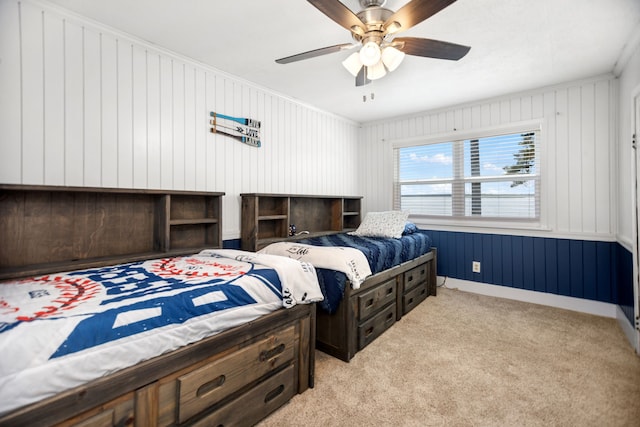 169 N County Road 4945, Etoile, TX 75944 - bedroom featuring light colored carpet, a ceiling fan, crown molding, and wooden walls