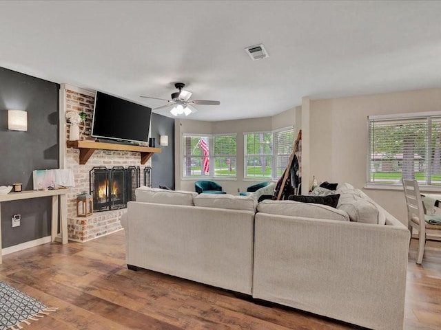 222 Beechnut Cir, Lufkin, TX 75904 - living area featuring a brick fireplace, ceiling fan, and wood finished floors