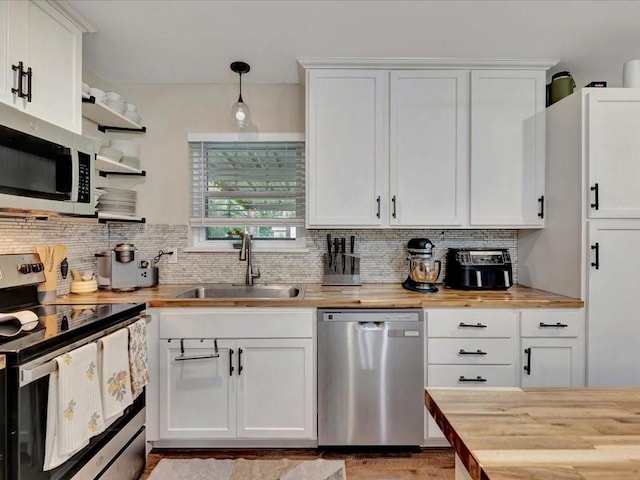 222 Beechnut Cir, Lufkin, TX 75904 - kitchen with appliances with stainless steel finishes, butcher block counters, open shelves, and white cabinets