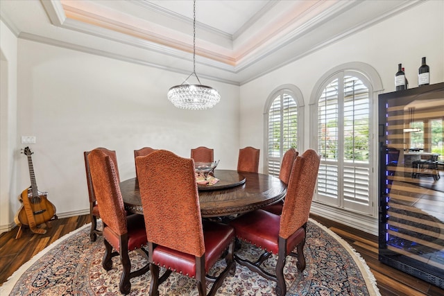 9603 Stonebridge Pl, Tomball, TX 77375 - dining space featuring crown molding, a tray ceiling, a chandelier, and wood finished floors