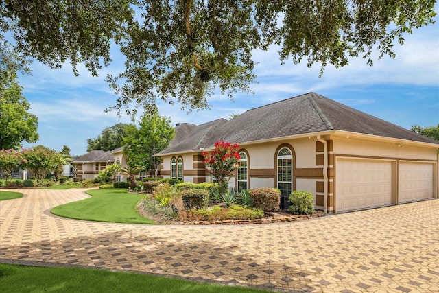 9603 Stonebridge Pl, Tomball, TX 77375 - single story home with stucco siding, decorative driveway, an attached garage, and roof with shingles