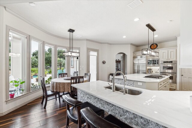 9603 Stonebridge Pl, Tomball, TX 77375 - kitchen featuring built in appliances, arched walkways, a kitchen island, light countertops, and recessed lighting