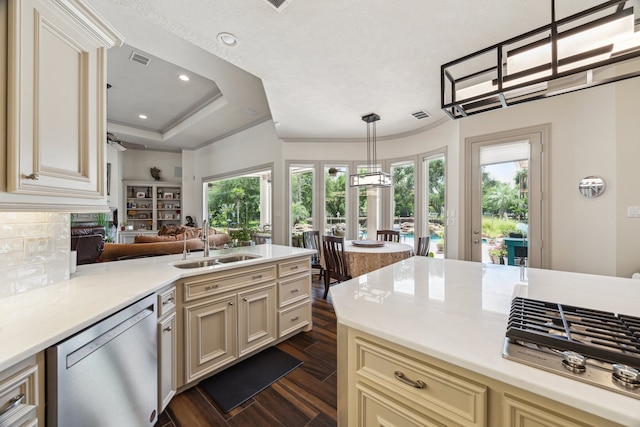 9603 Stonebridge Pl, Tomball, TX 77375 - kitchen with appliances with stainless steel finishes, cream cabinetry, light countertops, dark wood finished floors, and recessed lighting
