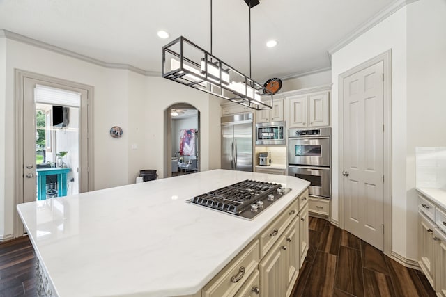 9603 Stonebridge Pl, Tomball, TX 77375 - kitchen featuring built in appliances, crown molding, light countertops, a kitchen island, and dark wood finished floors