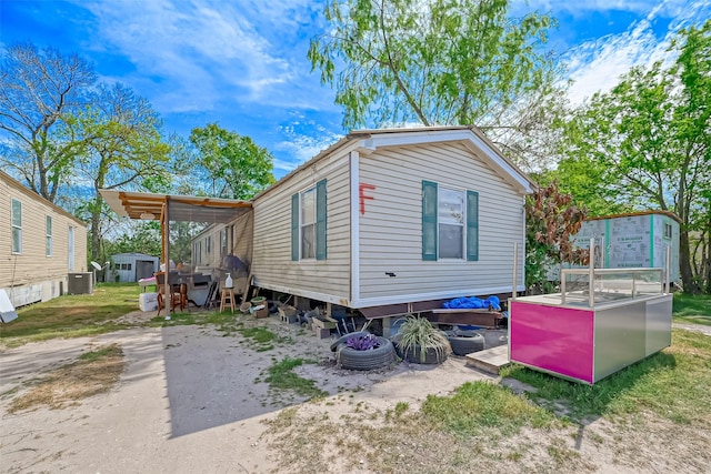 511 Gulf Bank Rd Unit 5, Houston, TX 77037 - view of property exterior with a storage shed and a cooling unit