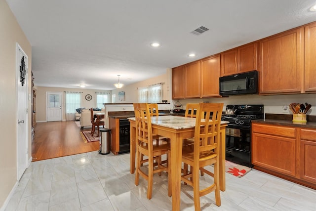 16307 Melody View Ct, Cypress, TX 77429 - kitchen featuring black appliances, brown cabinetry, recessed lighting, light marble finish floors, and open floor plan