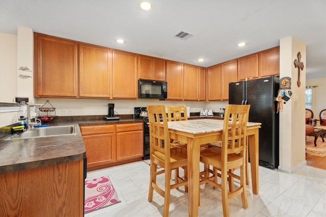 16307 Melody View Ct, Cypress, TX 77429 - kitchen with black appliances, dark countertops, recessed lighting, and light marble finish floors