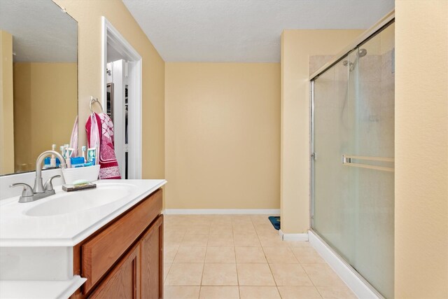 16307 Melody View Ct, Cypress, TX 77429 - bathroom with tile patterned flooring, a shower stall, vanity, and a textured ceiling