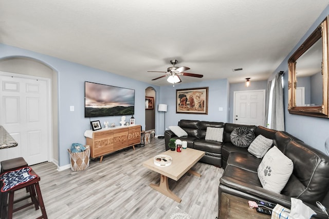 28961 San Bernard River Loop, Spring, TX 77386 - living room with arched walkways, ceiling fan, and wood finished floors