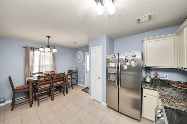 28961 San Bernard River Loop, Spring, TX 77386 - kitchen with stainless steel refrigerator with ice dispenser, a chandelier, stove, light tile patterned floors, and cream cabinetry