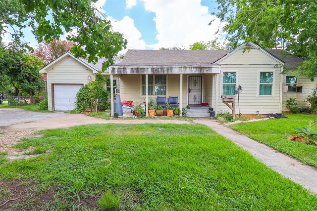 313 E Tidwell Rd, Houston, TX 77022 - view of front of home featuring a porch, a garage, a front lawn, driveway, and roof with shingles