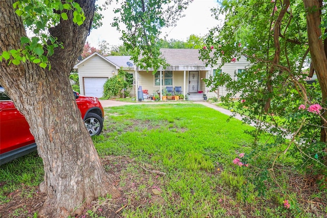 313 E Tidwell Rd, Houston, TX 77022 - ranch-style house featuring an attached garage, a front lawn, roof with shingles, driveway, and covered porch