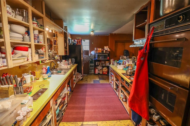 313 E Tidwell Rd, Houston, TX 77022 - kitchen with stainless steel appliances, open shelves, and dark colored carpet