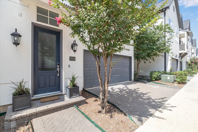 3410 Timbergrove Heights St, Houston, TX 77008 - doorway to property with decorative driveway, stucco siding, and an attached garage