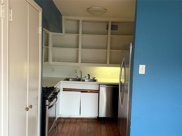 1226 W Drew St Unit B, Houston, TX 77006 - kitchen with stainless steel appliances, white cabinets, light countertops, and dark wood finished floors