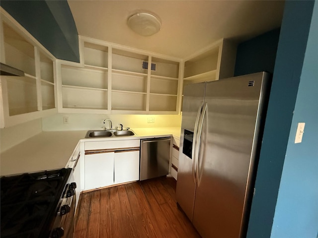 1226 W Drew St Unit B, Houston, TX 77006 - kitchen featuring stainless steel appliances, open shelves, white cabinetry, light countertops, and dark wood finished floors