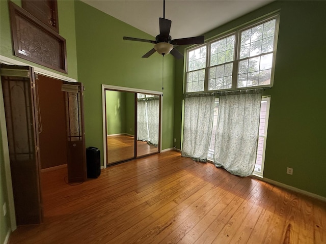 1226 W Drew St Unit B, Houston, TX 77006 - unfurnished bedroom featuring a towering ceiling, hardwood / wood-style flooring, and a closet