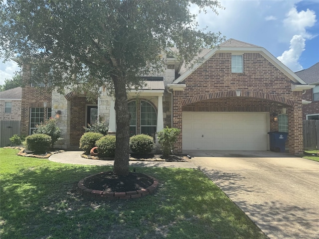 4714 Loggia Ln, Humble, TX 77396 - view of front of property featuring driveway, brick siding, a garage, and stone siding