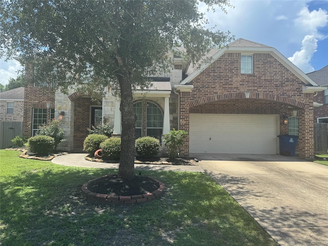 4714 Loggia Ln, Humble, TX 77396 - view of front of property featuring concrete driveway, brick siding, stone siding, and an attached garage