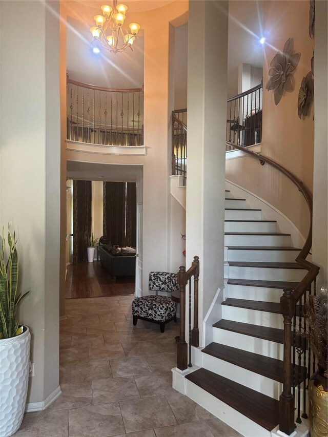 4714 Loggia Ln, Humble, TX 77396 - stairway with a high ceiling and a chandelier