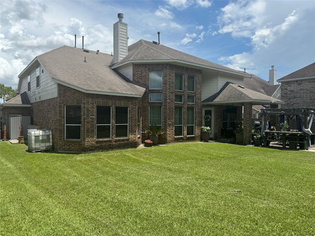 4714 Loggia Ln, Humble, TX 77396 - rear view of property with a yard, brick siding, and a shingled roof