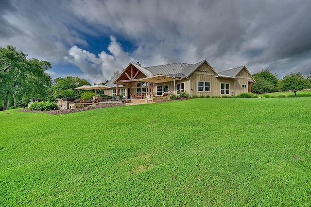 39577 Mesquite Dr, Hempstead, TX 77445 - rear view of property featuring board and batten siding, a lawn, and a metal roof