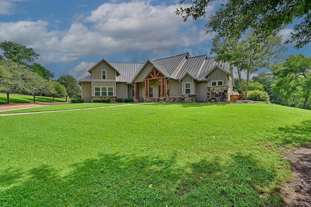 39577 Mesquite Dr, Hempstead, TX 77445 - view of front of house with board and batten siding, a front yard, and a metal roof
