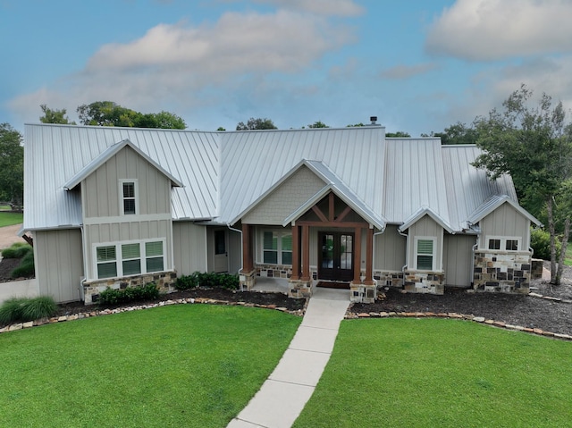 39577 Mesquite Dr, Hempstead, TX 77445 - craftsman inspired home featuring french doors, a front lawn, board and batten siding, stone siding, and a metal roof