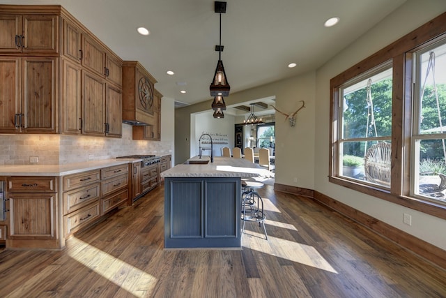 39577 Mesquite Dr, Hempstead, TX 77445 - kitchen with dark wood-style flooring, light countertops, backsplash, recessed lighting, and brown cabinetry