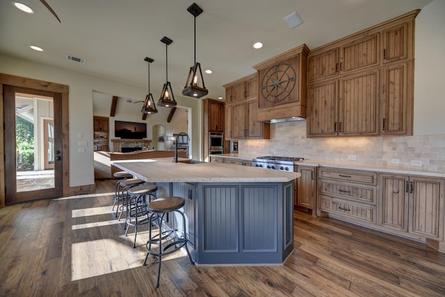 39577 Mesquite Dr, Hempstead, TX 77445 - kitchen with light countertops, a center island with sink, dark wood-style flooring, backsplash, and recessed lighting