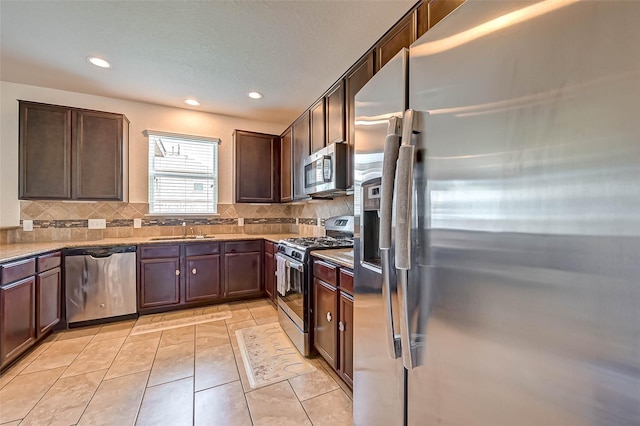 3306 Coopers Ridge Way, Houston, TX 77084 - kitchen with stainless steel appliances, tasteful backsplash, recessed lighting, and dark brown cabinetry