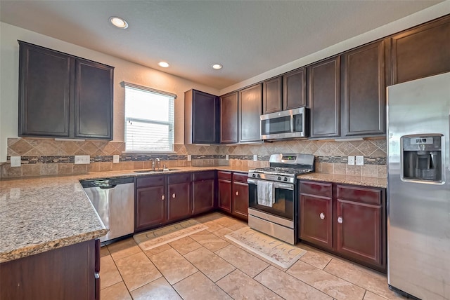 3306 Coopers Ridge Way, Houston, TX 77084 - kitchen with stainless steel appliances, backsplash, recessed lighting, light tile patterned flooring, and light stone counters