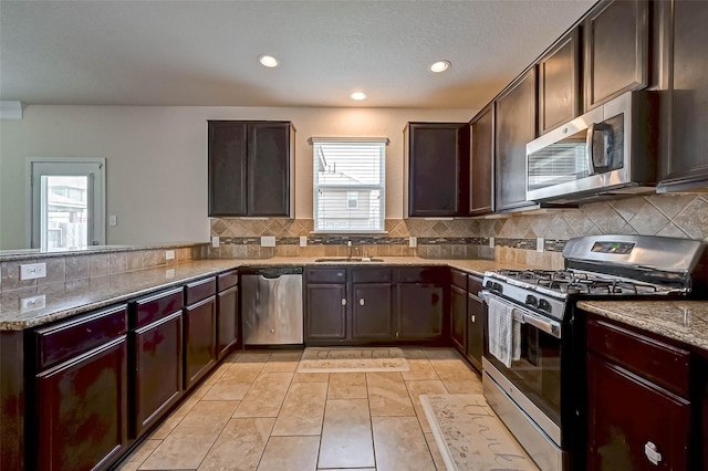 3306 Coopers Ridge Way, Houston, TX 77084 - kitchen with stainless steel appliances, healthy amount of natural light, a peninsula, recessed lighting, and decorative backsplash