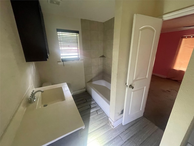 26603 N Marek Ln, Magnolia, TX 77355 - full bathroom featuring a tub to relax in, wood finished floors, vanity, and a shower