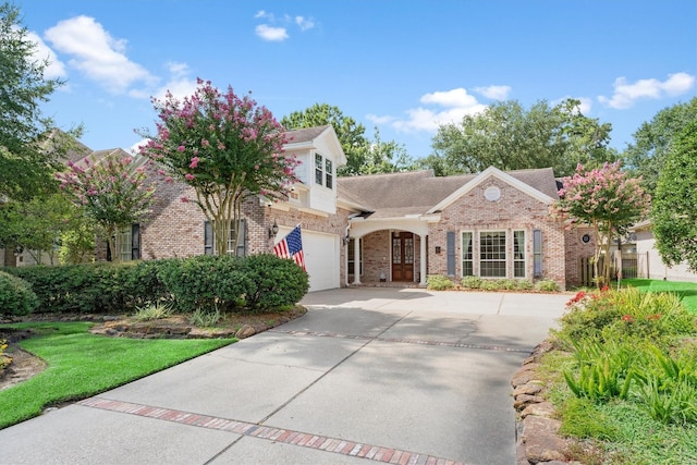 15 S Lakemist Harbour Pl, The Woodlands, TX 77381 - view of front of property featuring driveway, brick siding, a front lawn, and roof with shingles