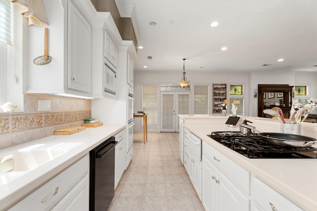15 S Lakemist Harbour Pl, The Woodlands, TX 77381 - kitchen featuring black appliances, recessed lighting, decorative backsplash, white cabinetry, and light countertops