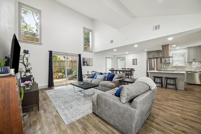 8218 Waynemer Way, Houston, TX 77040 - living area with high vaulted ceiling, wood finished floors, and recessed lighting
