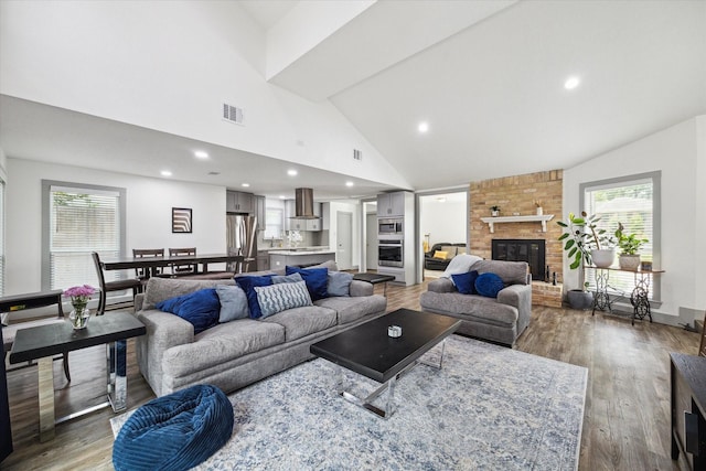 8218 Waynemer Way, Houston, TX 77040 - living area with high vaulted ceiling, wood finished floors, plenty of natural light, a fireplace, and recessed lighting