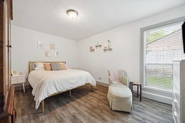 8218 Waynemer Way, Houston, TX 77040 - bedroom featuring wood finished floors and a textured ceiling