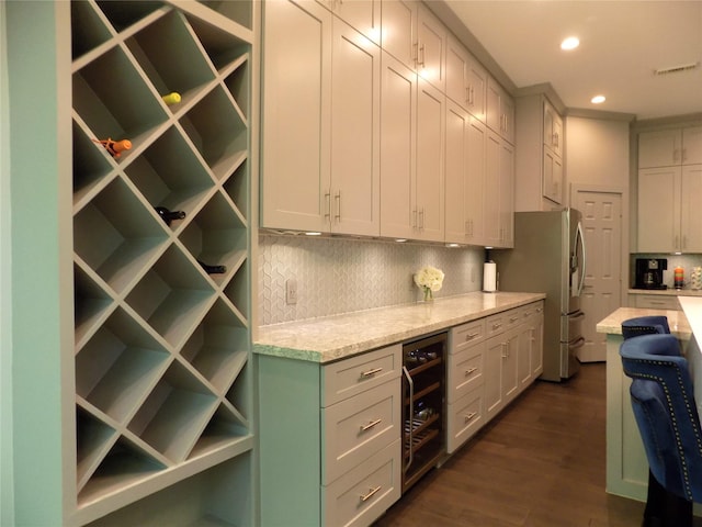 12636 Briar Patch Rd, Houston, TX 77077 - kitchen with beverage cooler, freestanding refrigerator, decorative backsplash, dark wood-type flooring, and recessed lighting