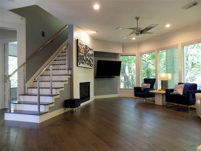 12636 Briar Patch Rd, Houston, TX 77077 - living room featuring a ceiling fan, wood-type flooring, recessed lighting, a glass covered fireplace, and crown molding