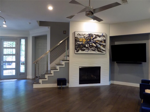 12636 Briar Patch Rd, Houston, TX 77077 - living area featuring ornamental molding, ceiling fan, stairway, wood finished floors, and a fireplace