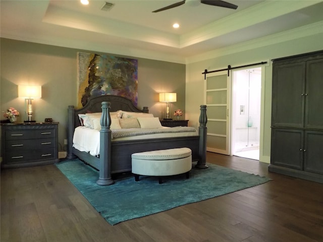 12636 Briar Patch Rd, Houston, TX 77077 - bedroom featuring dark wood-type flooring, a tray ceiling, ornamental molding, a barn door, and recessed lighting