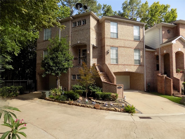 12636 Briar Patch Rd, Houston, TX 77077 - view of front of property featuring brick siding, a garage, and concrete driveway