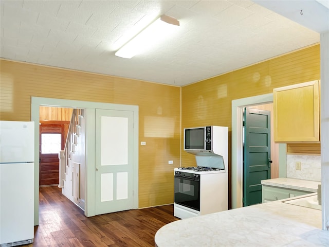 1233 Eagle Lake Rd, Sealy, TX 77474 - kitchen featuring white appliances, dark wood-style flooring, and light countertops